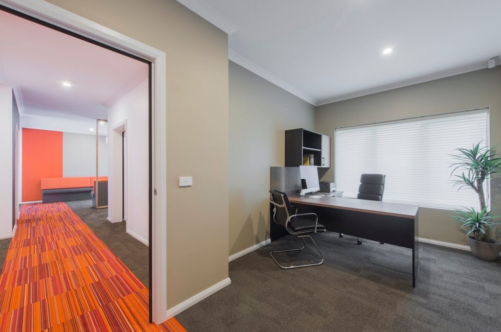 Medical practice with coloured carpet to help with wayfinding