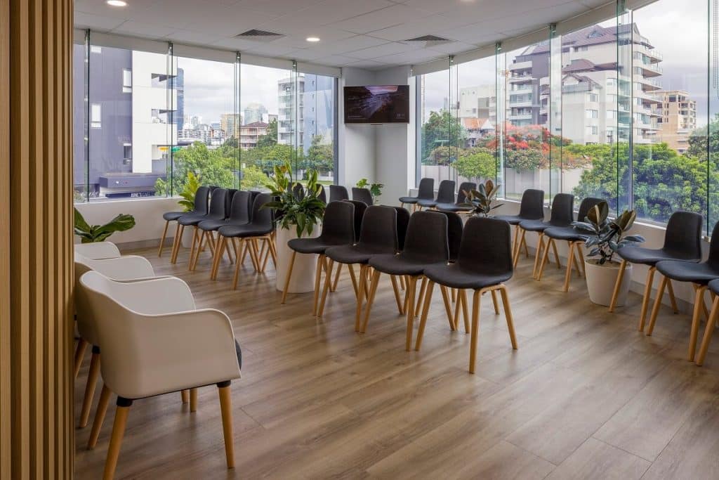 Medical practice reception with large windows, flooding the room with natural light